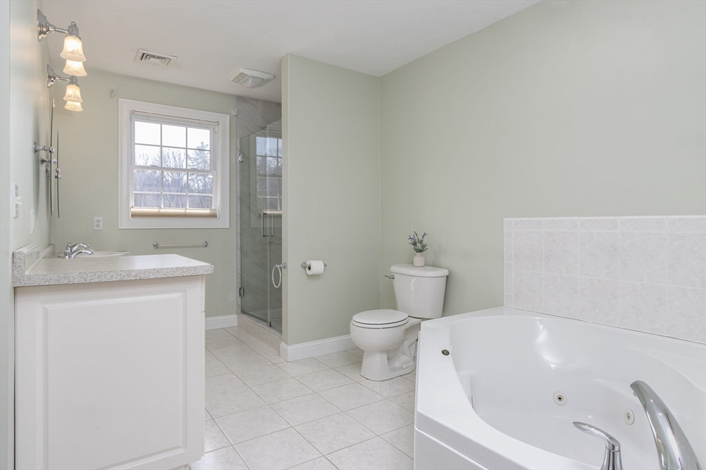 256 Lowell Road Groton, MA 01450 - Photo 25 of 40 a bathroom with a granite countertop sink a toilet and bathtub