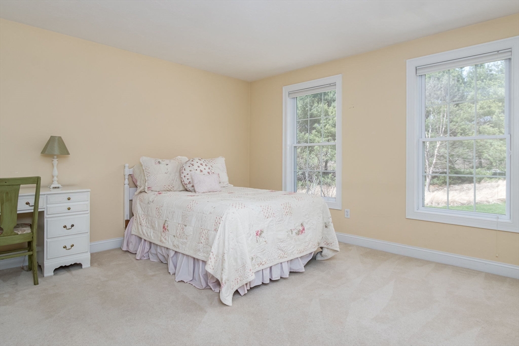 256 Lowell Road Groton, MA 01450 - Photo 27 of 40 a spacious bedroom with a bed and a window