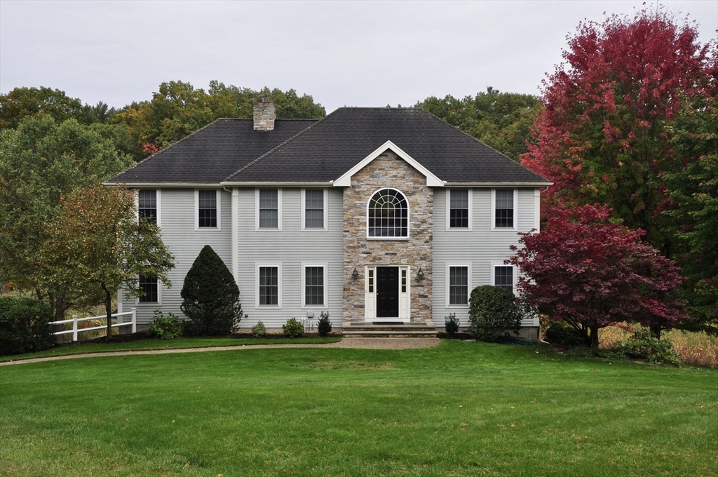 256 Lowell Road Groton, MA 01450 - Photo 3 of 40 a front view of house with yard and green space