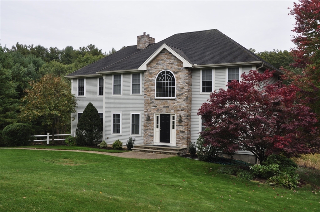 256 Lowell Road Groton, MA 01450 - Photo 36 of 40 a front view of a house with garden