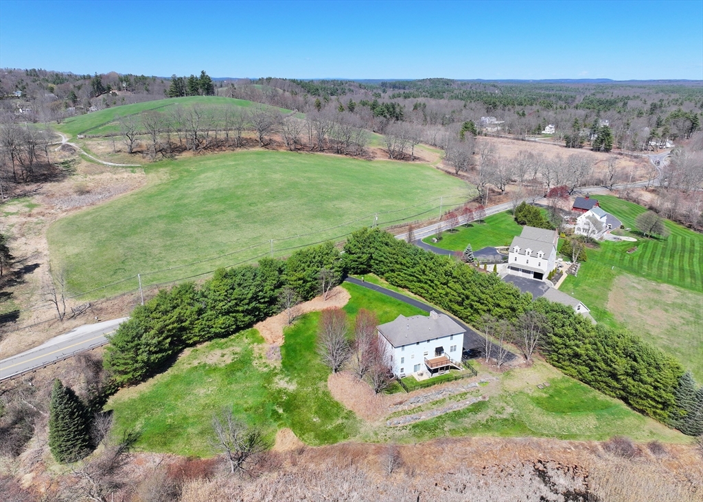 256 Lowell Road Groton, MA 01450 - Photo 4 of 40 an aerial view of a house with a garden