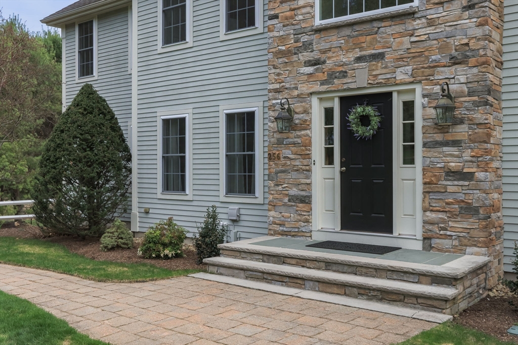 256 Lowell Road Groton, MA 01450 - Photo 5 of 40 a front view of a house with a garden