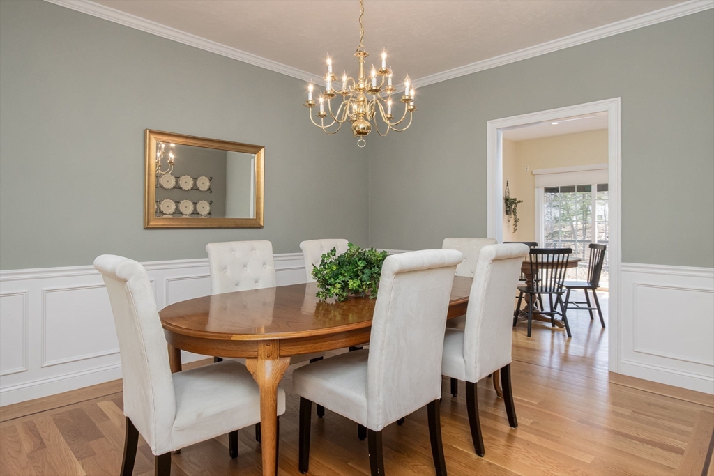 256 Lowell Road Groton, MA 01450 - Photo 9 of 40 a view of a dining room with furniture and wooden floor