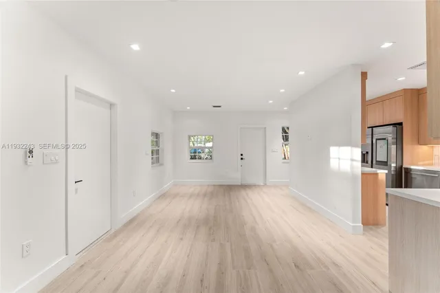 a kitchen with stainless steel appliances a refrigerator a stove a sink and a refrigerator