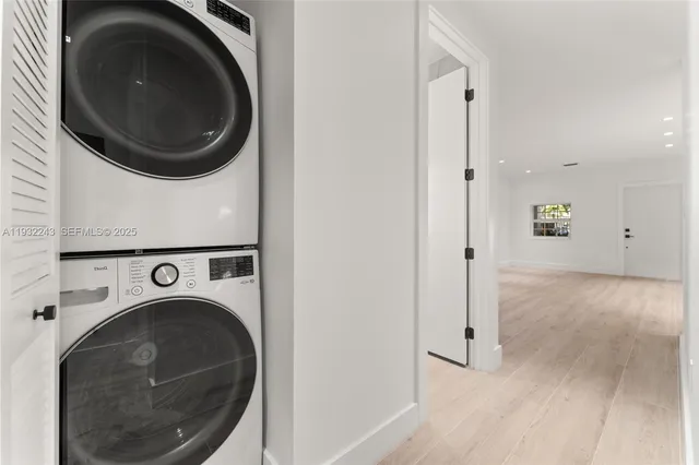 a room with a wooden floor and mirror