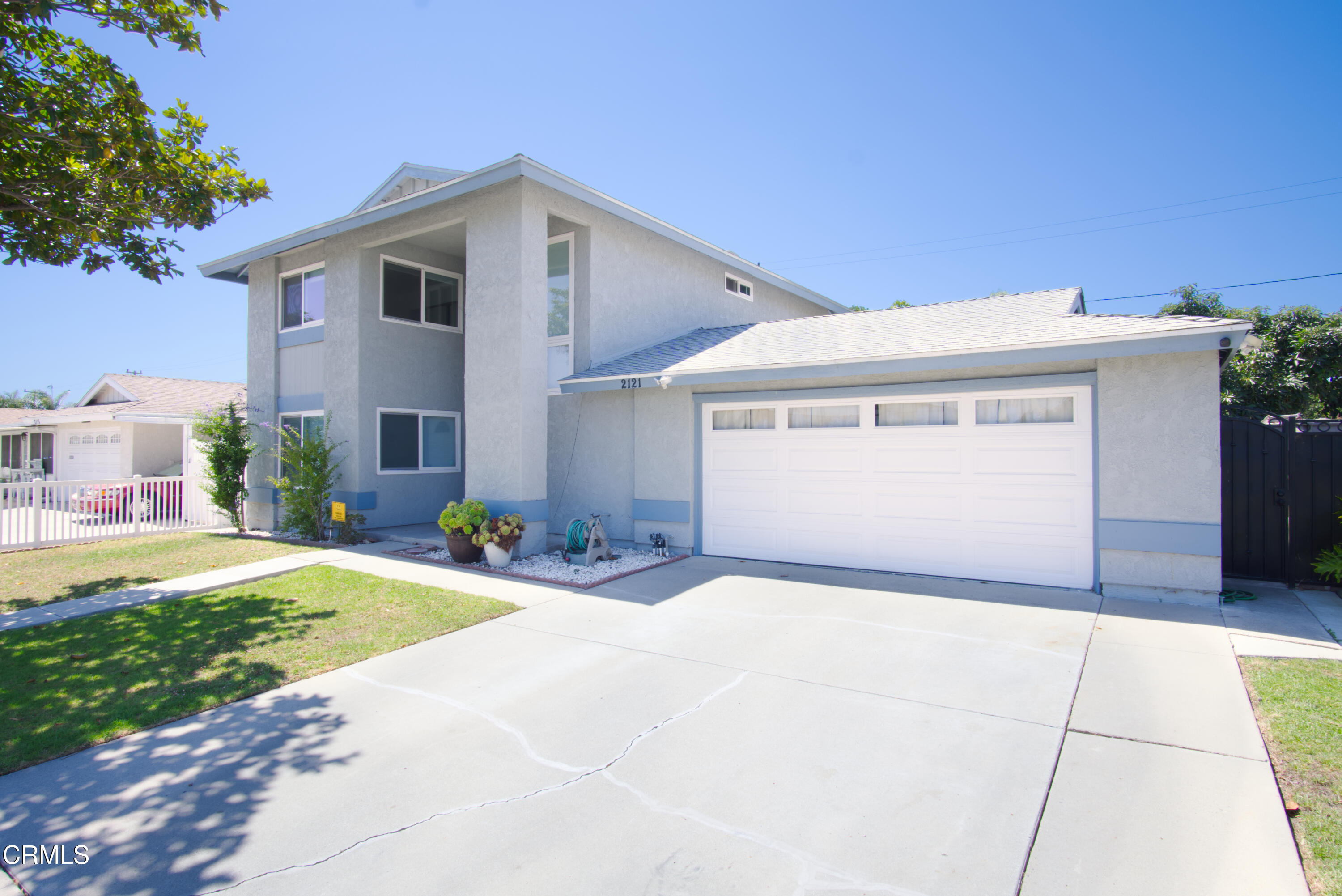 2121 Ironbark Drive Oxnard, CA 93036 - Photo 1 of 13 a front view of a house with a yard and garage