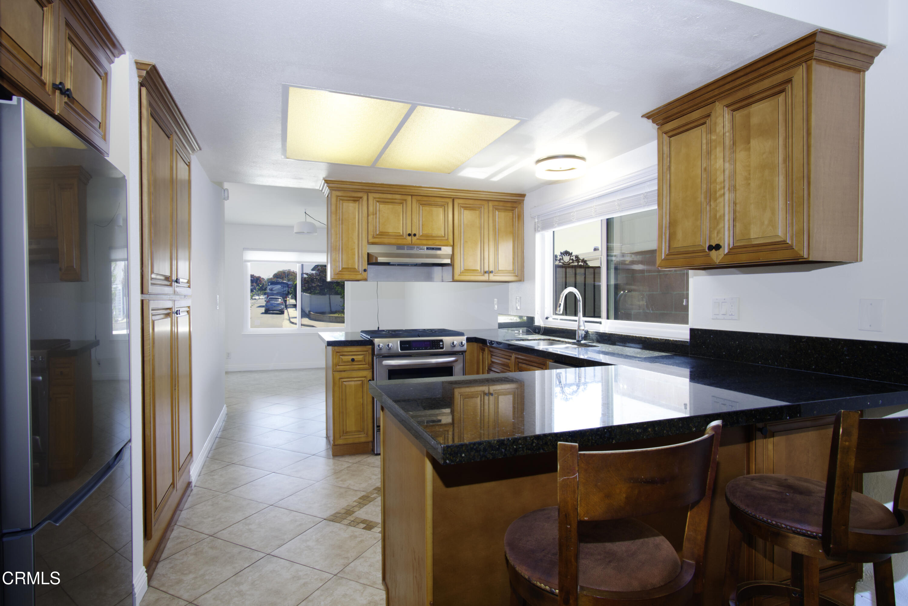 2121 Ironbark Drive Oxnard, CA 93036 - Photo 3 of 13 a kitchen with granite countertop a sink cabinets and stainless steel appliances