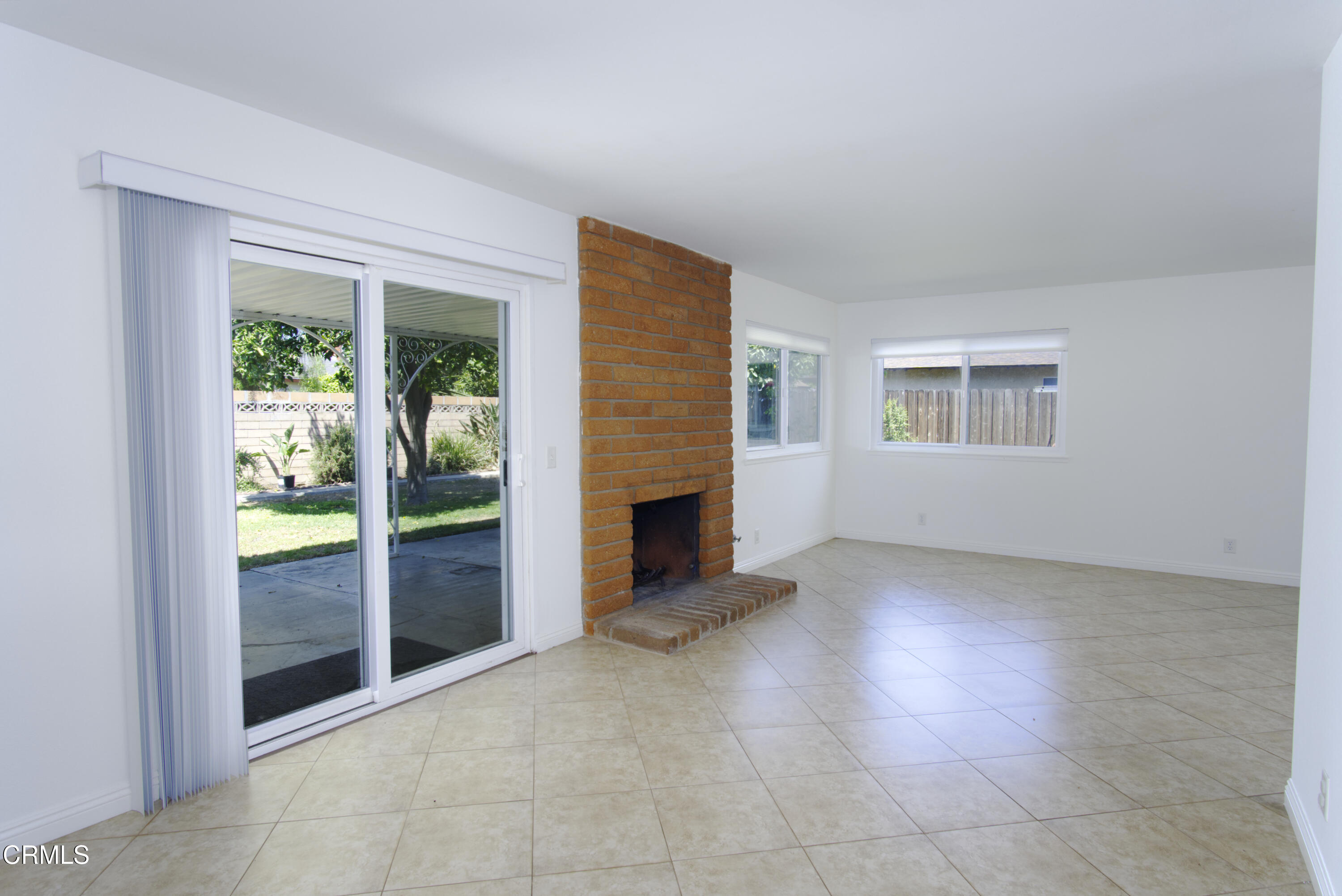 2121 Ironbark Drive Oxnard, CA 93036 - Photo 4 of 13 an empty room with windows and fireplace
