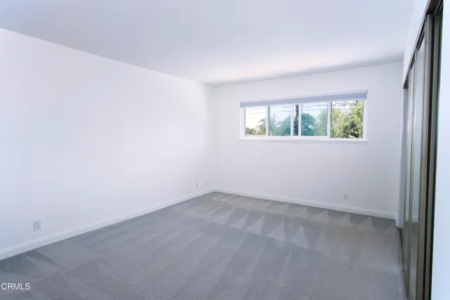 a bathroom with a granite countertop bathtub shower and toilet