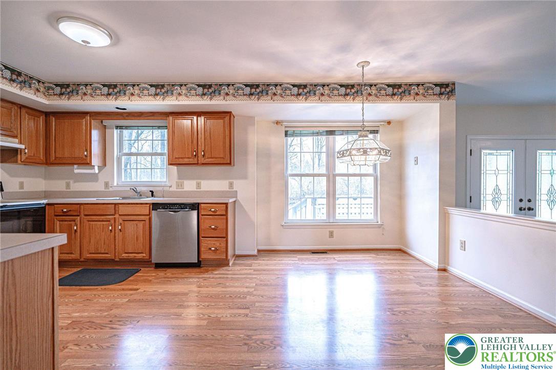 40 Elk Court Reading, PA 19606 - Photo 17 of 46 a kitchen with stainless steel appliances granite countertop a stove a sink wooden cabinets and a wooden floor
