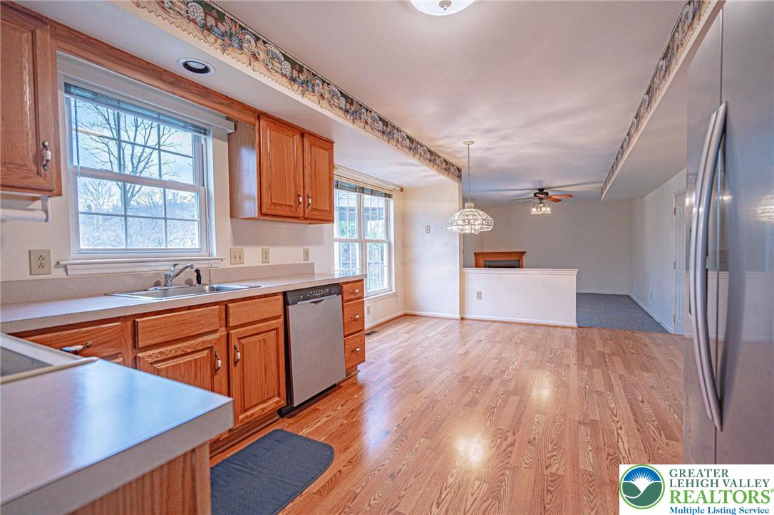 40 Elk Court Reading, PA 19606 - Photo 22 of 46 a kitchen with stainless steel appliances granite countertop a sink a stove and wooden floors