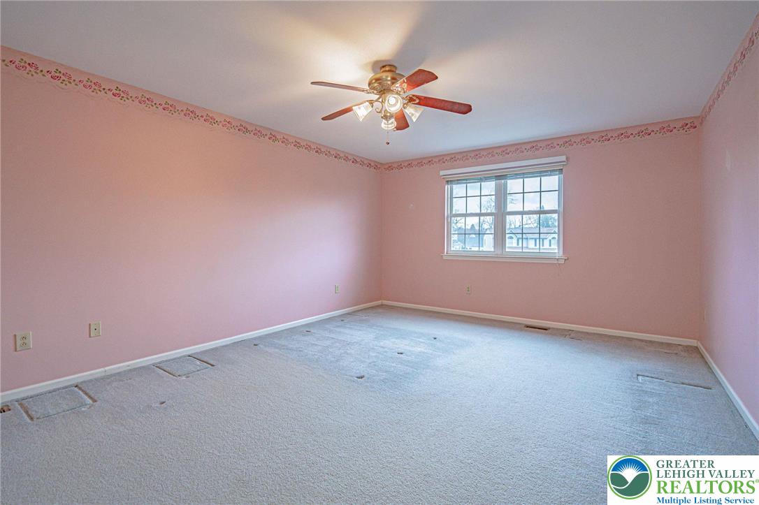 40 Elk Court Reading, PA 19606 - Photo 26 of 46 an empty room with a chandelier fan and windows