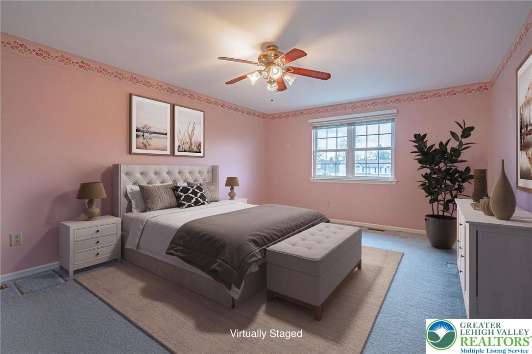 40 Elk Court Reading, PA 19606 - Photo 27 of 46 a bedroom with a large bed and a chandelier