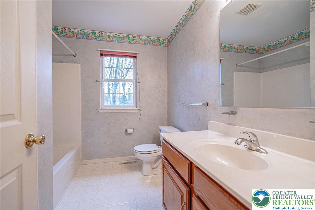 40 Elk Court Reading, PA 19606 - Photo 34 of 46 a bathroom with a sink a toilet and a mirror