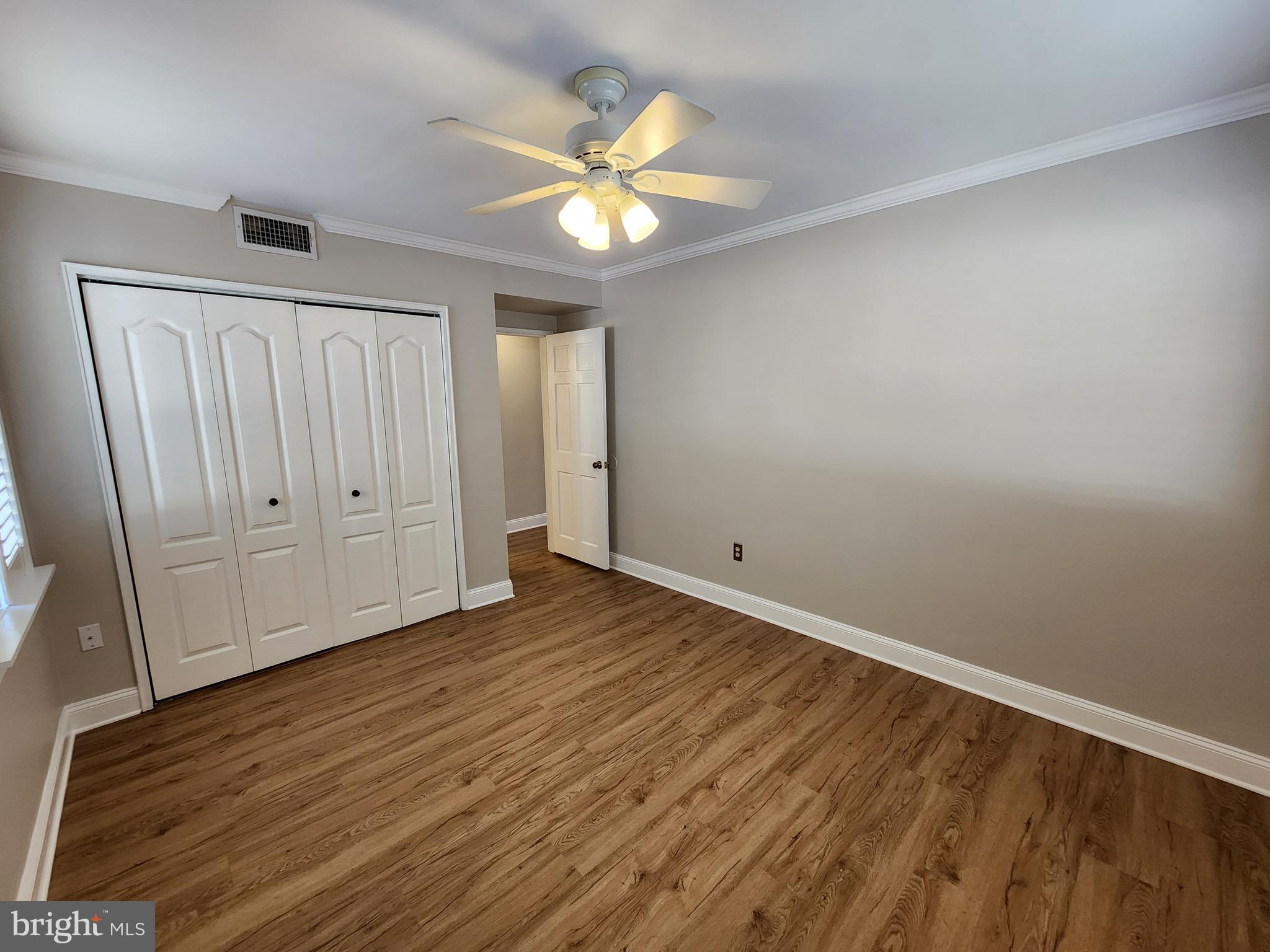 2610 Tunlaw Road Northwest, Unit 103 Washington, DC 20007 - Photo 13 of 36 a view of an empty room with wooden floor