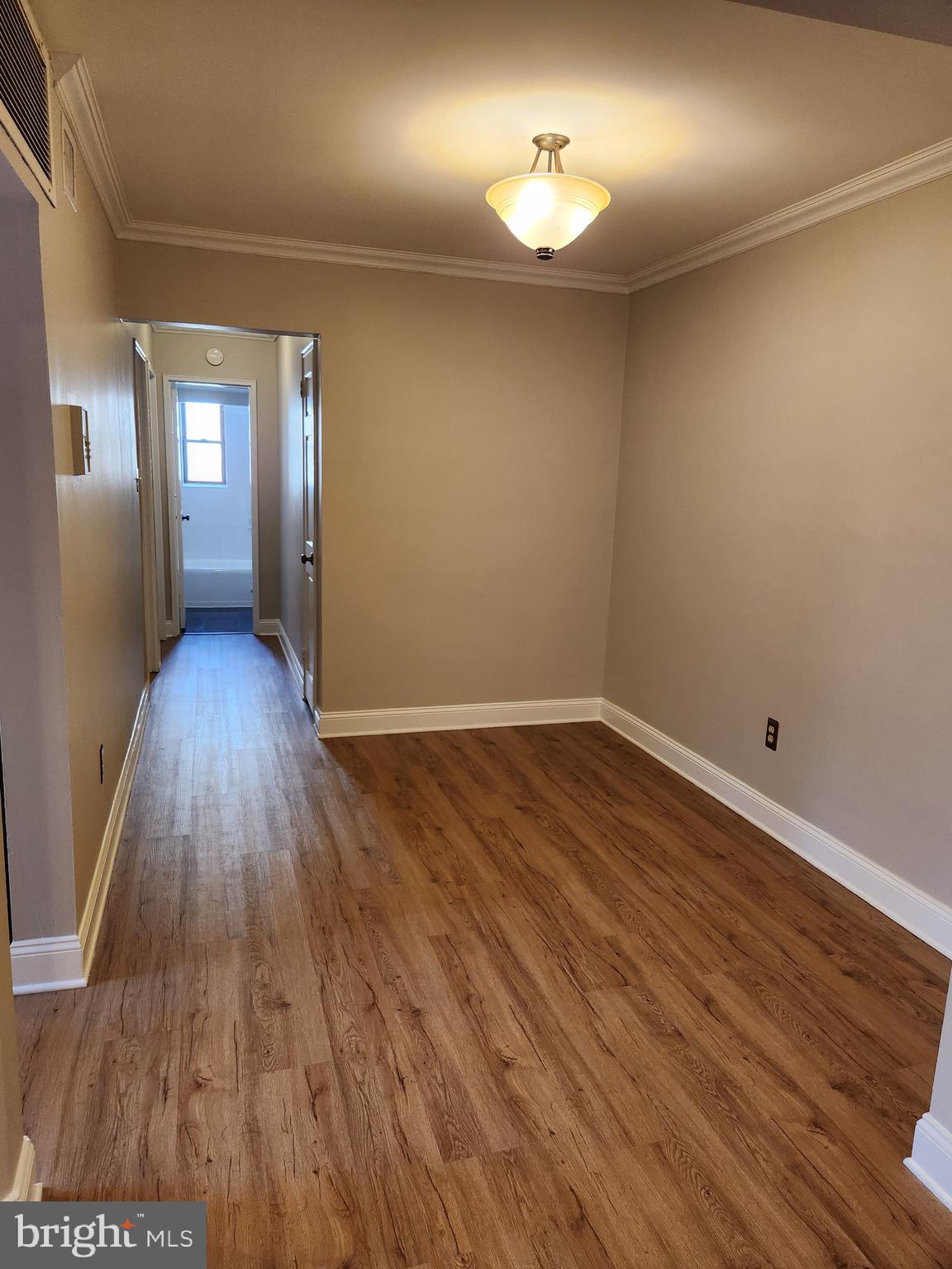 2610 Tunlaw Road Northwest, Unit 103 Washington, DC 20007 - Photo 17 of 36 a view of empty room with wooden floor