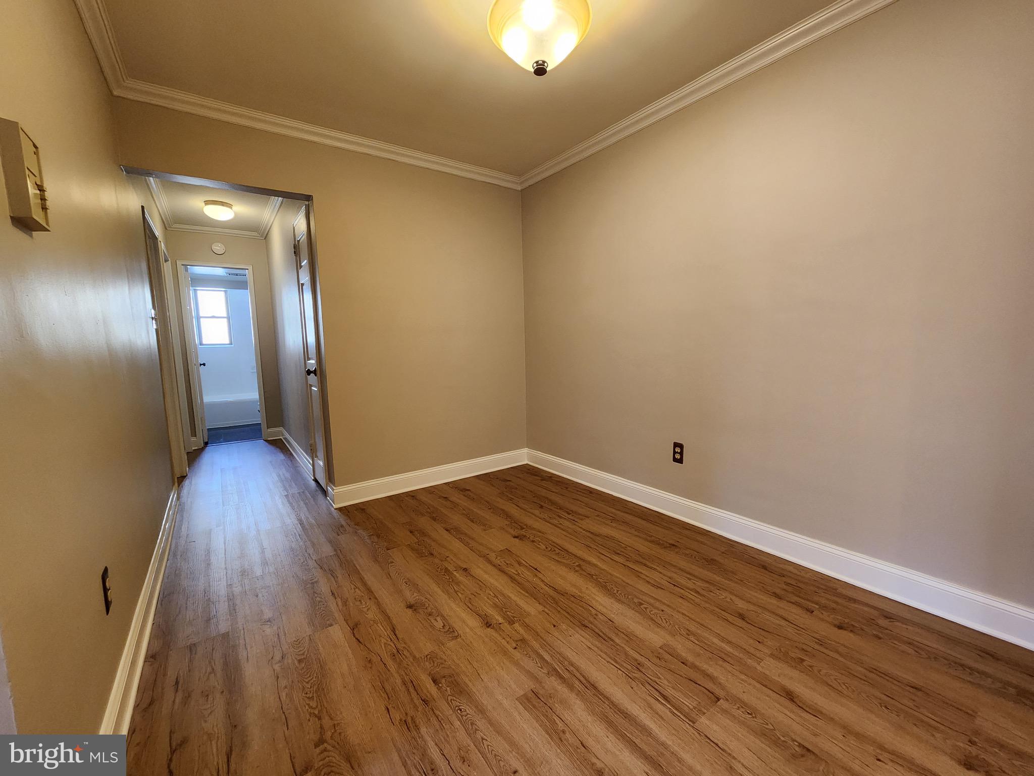 2610 Tunlaw Road Northwest, Unit 103 Washington, DC 20007 - Photo 18 of 36 a view of a room with wooden floor