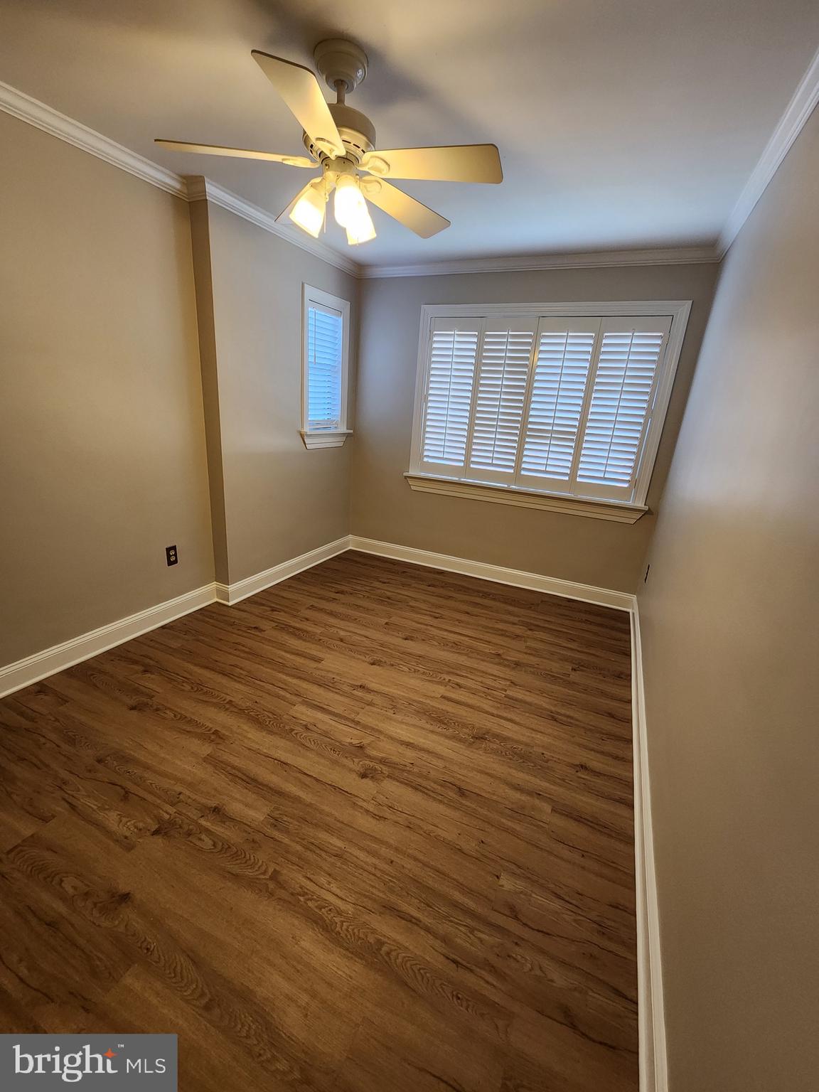 2610 Tunlaw Road Northwest, Unit 103 Washington, DC 20007 - Photo 19 of 36 a view of an empty room with window and chandelier fan
