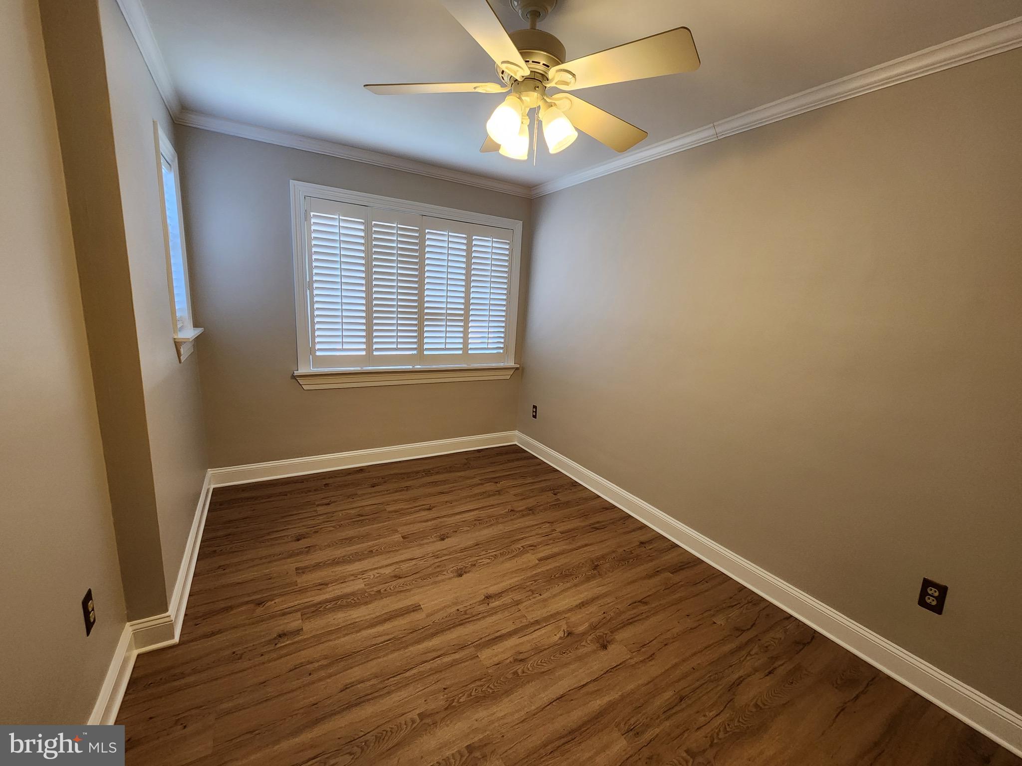 2610 Tunlaw Road Northwest, Unit 103 Washington, DC 20007 - Photo 20 of 36 an empty room with wooden floor and windows