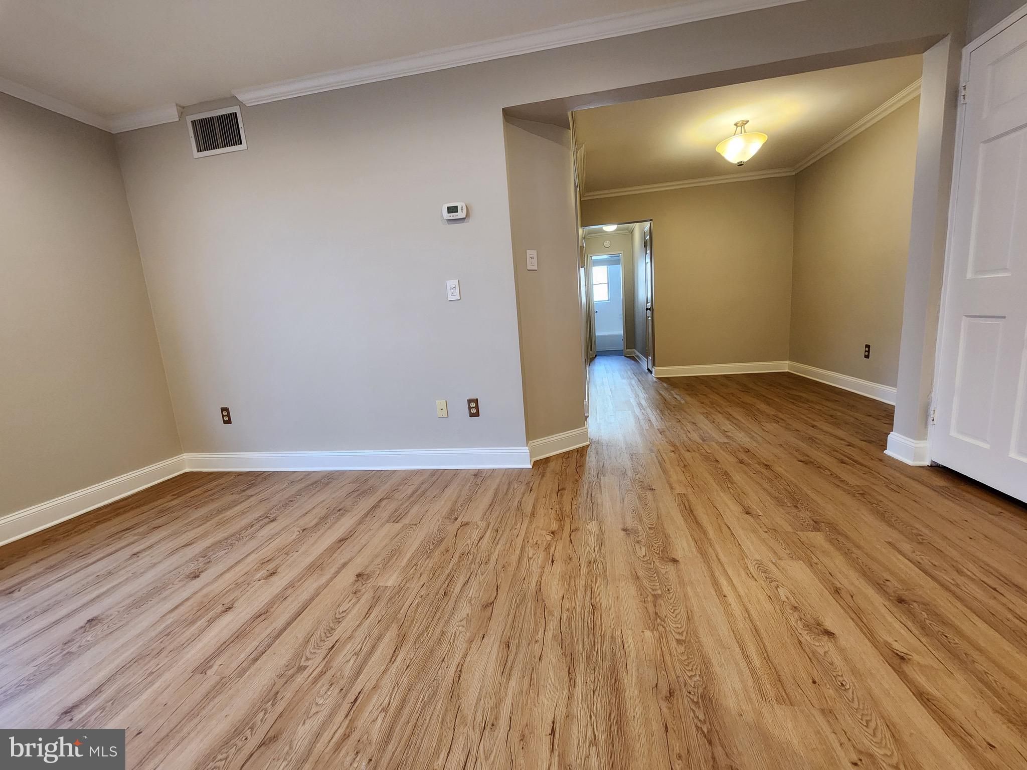 2610 Tunlaw Road Northwest, Unit 103 Washington, DC 20007 - Photo 26 of 36 wooden floor in an empty room