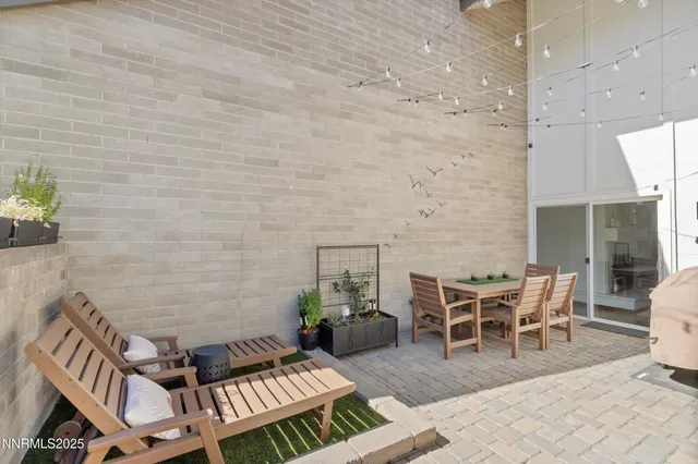 a view of a patio with table and chairs and wooden floor