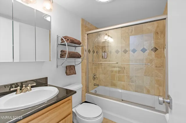 a kitchen with granite countertop a stove a sink and dishwasher wooden cabinets with granite countertops