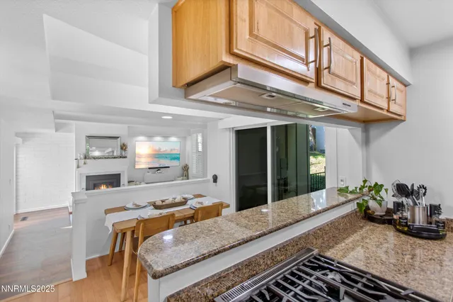 a kitchen with stainless steel appliances granite countertop a refrigerator sink and stove