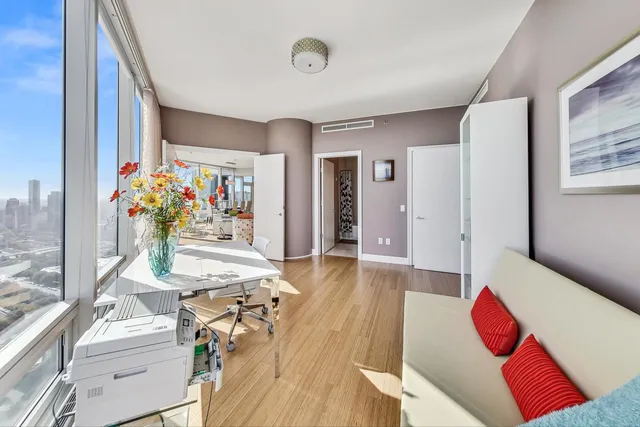 a living room with furniture and flowers