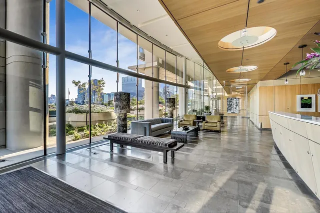 a living room with lots of furniture and a large window