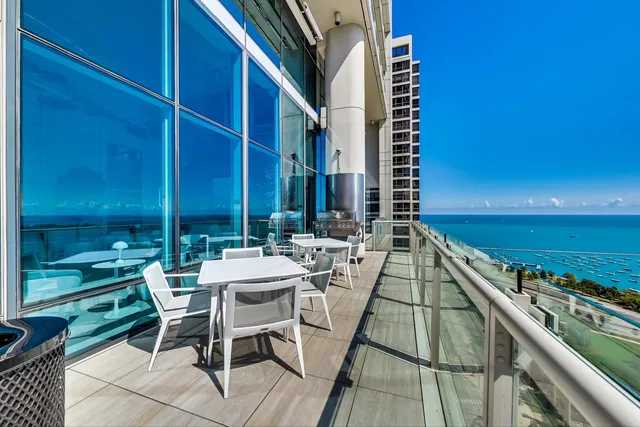 a view of a patio with couches table and chairs and potted plants