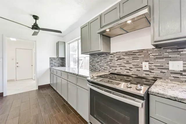 a kitchen with granite countertop a sink and a window