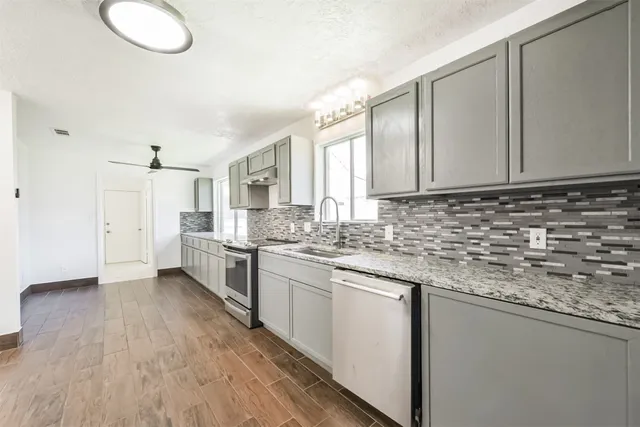 a large white room with a large window and double vanity