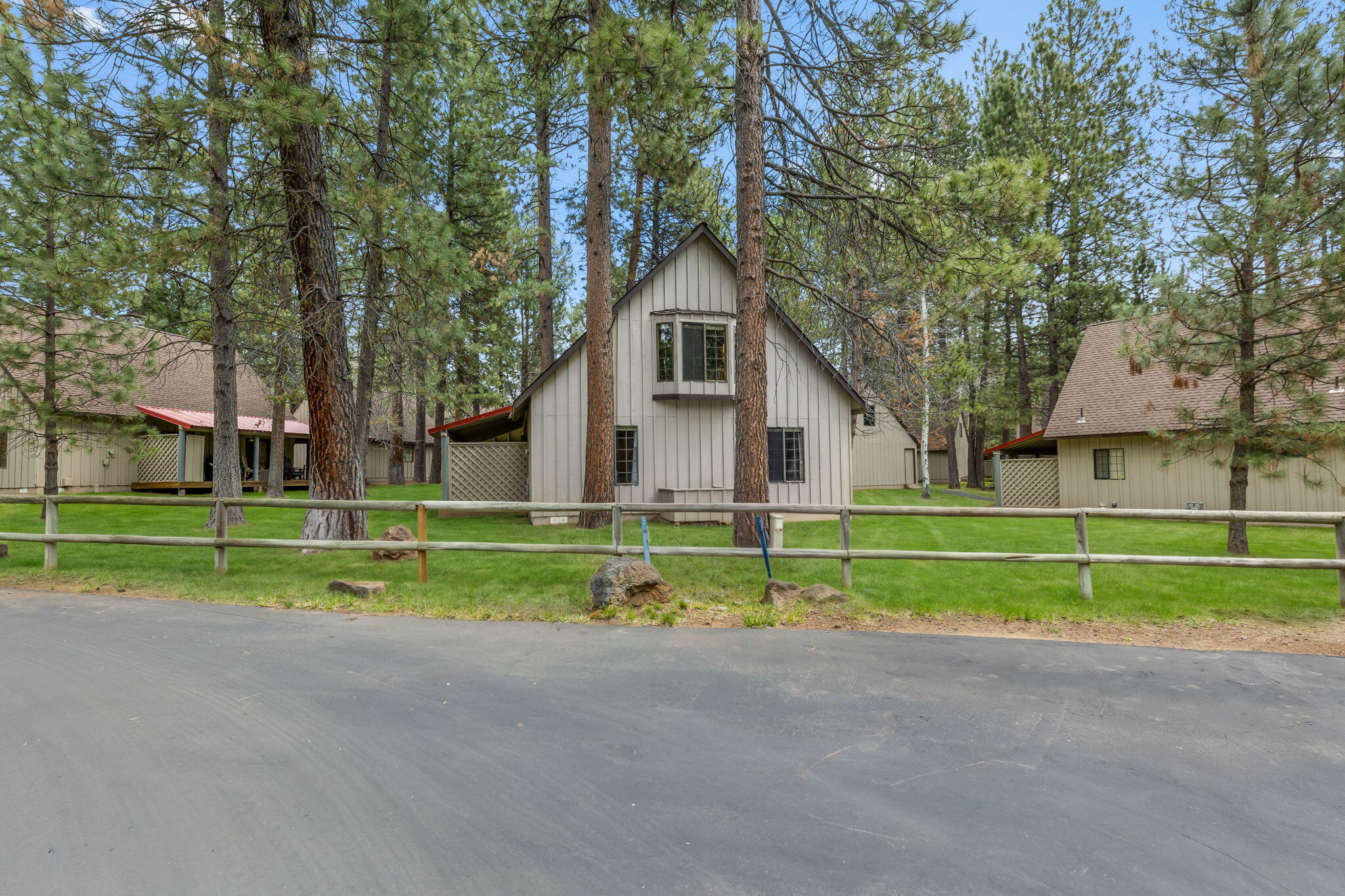 57505 Circle 4 Cabin Road, Unit 29 Sunriver, OR 97707 - Photo 32 of 35 a house view with a play ground in front of it