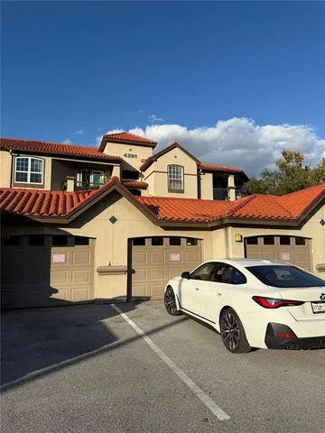 a front view of a house with parking space