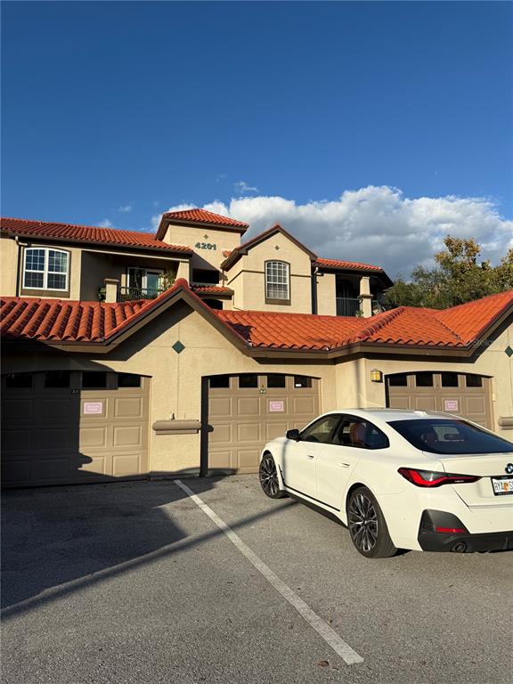 a front view of a house with parking space