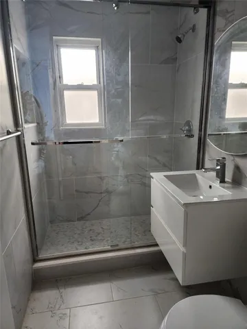 a bathroom with a sink a mirror and a shower