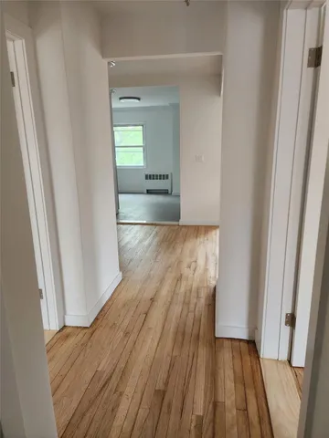 a view of a room with wooden floor and staircase