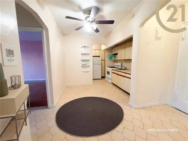 a view of a kitchen with furniture and stainless steel appliances