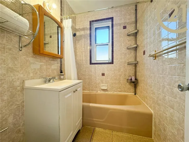 a bathroom with a sink a mirror and a bathtub