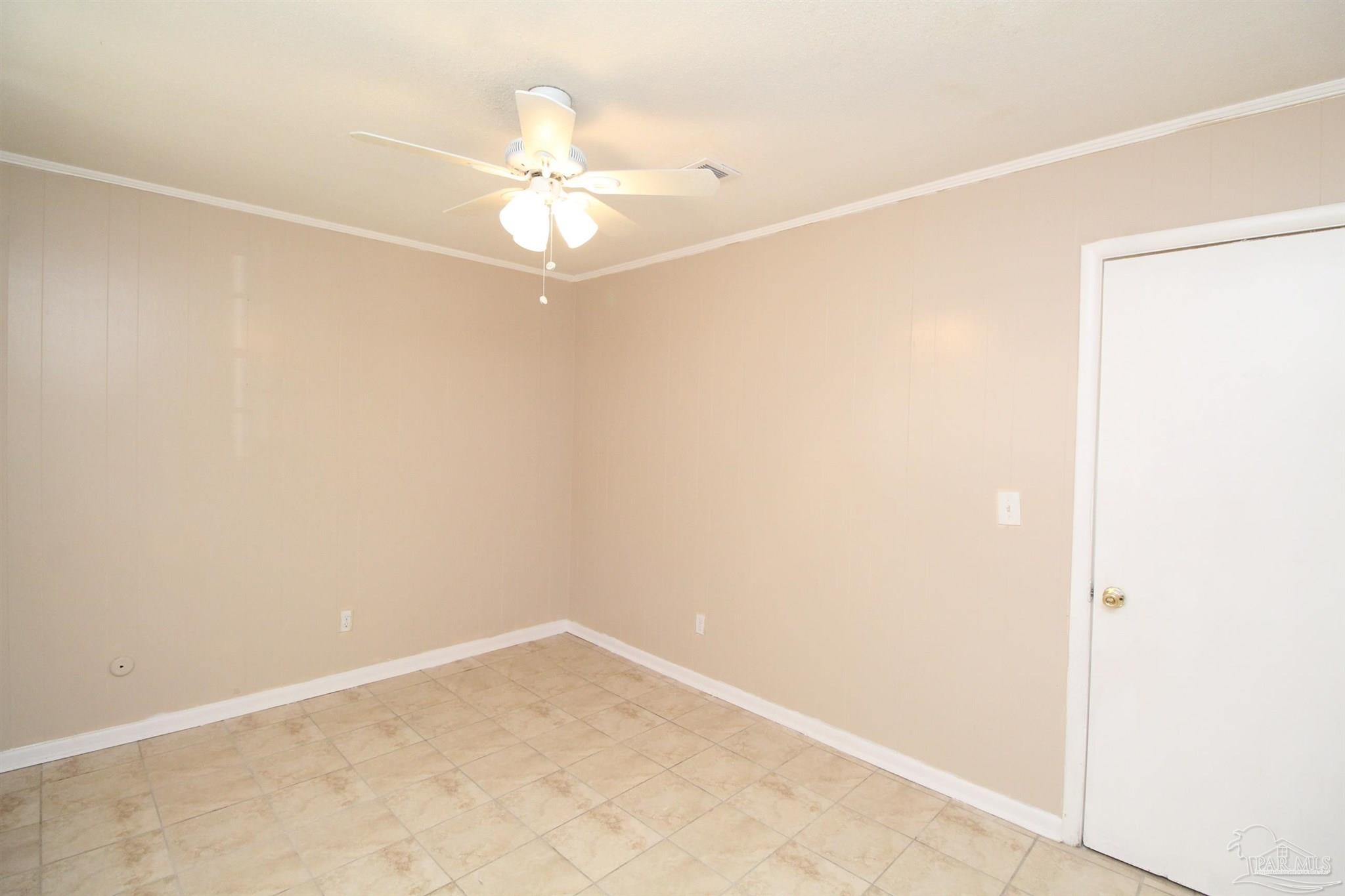 6620 Applegate Street Milton, FL 32570 - Photo 8 of 12 an empty room with a window and a fan