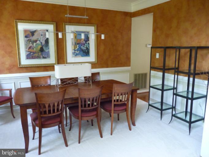 3721 Katie Place Triangle, VA 22172 - Photo 12 of 27 a view of a dining room with furniture a rug and wooden floor