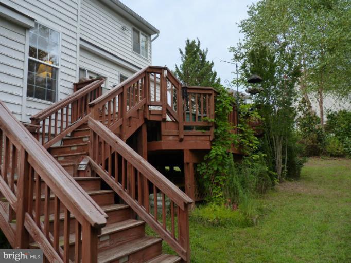 3721 Katie Place Triangle, VA 22172 - Photo 17 of 27 a front view of house along with deck and trees