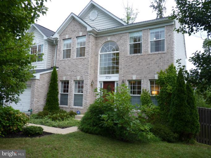 3721 Katie Place Triangle, VA 22172 - Photo 3 of 27 a front view of a house with a yard and trees