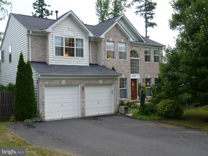 3721 Katie Place Triangle, VA 22172 - Photo 27 of 27 a front view of a house with a yard and garage