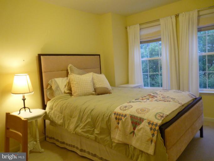 3721 Katie Place Triangle, VA 22172 - Photo 10 of 27 a bedroom with a bed and lamp