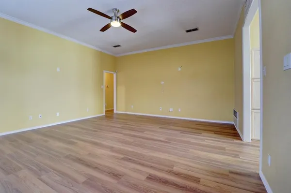 a view of empty room with wooden floor