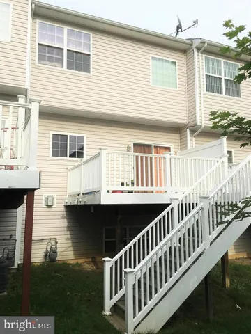 a wooden bench sitting in front of a tree