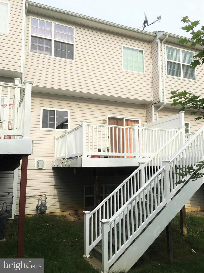 14030 Castle Ridge Way, Unit 27 Silver Spring, MD 20904 - Photo 17 of 19 a view of a house with wooden deck