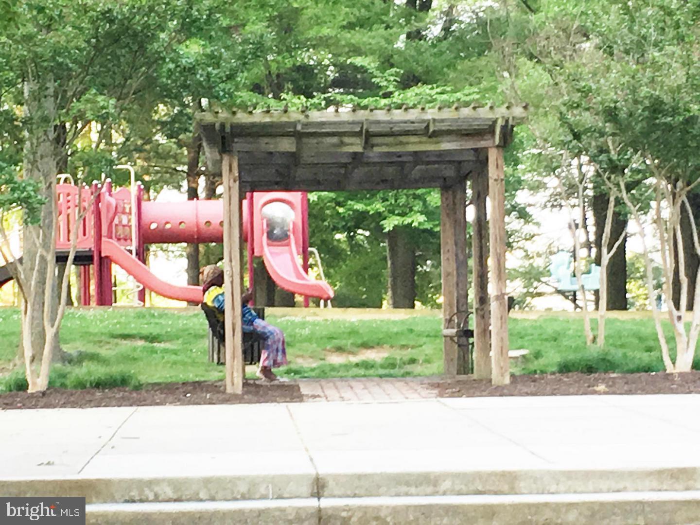 14030 Castle Ridge Way, Unit 27 Silver Spring, MD 20904 - Photo 18 of 19 a wooden bench sitting in front of a tree