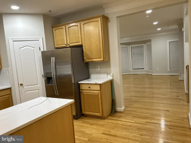 a kitchen with stainless steel appliances a refrigerator sink and wooden cabinets